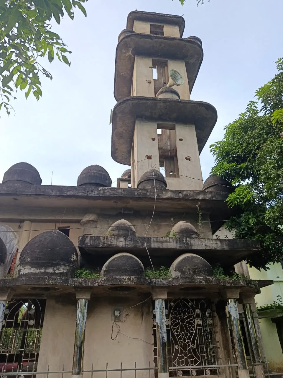 A mosque minaret and domes seen from below